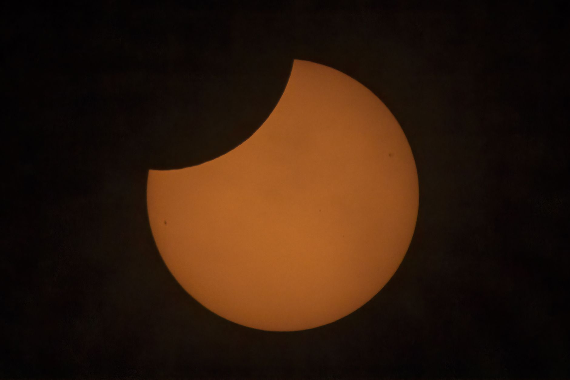 partial solar eclipse against dark sky
